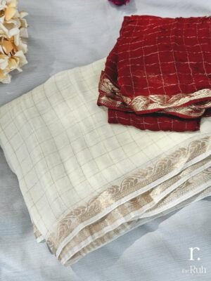 Graceful tissue checked saree with a subtle golden sheen 🌿 Paired with a rich maroon blouse fea Premium Checked Viscous Georgette Saree